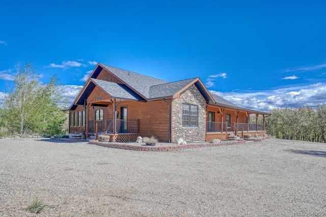 8126 Buck Run, Salida, CO 81201 - view of side of property with covered porch, stone siding, and roof with shingles