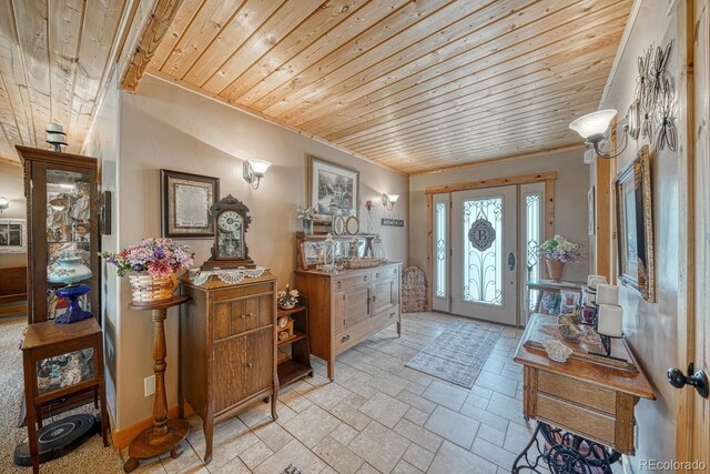 8126 Buck Run, Salida, CO 81201 - foyer entrance featuring wood ceiling, ornamental molding, and light stone finish flooring