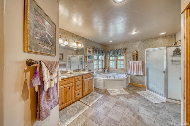 8126 Buck Run, Salida, CO 81201 - bathroom with a stall shower, double vanity, a bath, recessed lighting, and baseboards