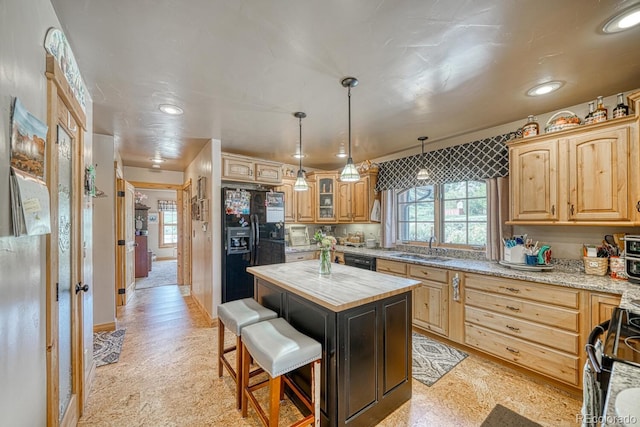 8126 Buck Run, Salida, CO 81201 - kitchen featuring black appliances, healthy amount of natural light, a sink, a center island, and recessed lighting