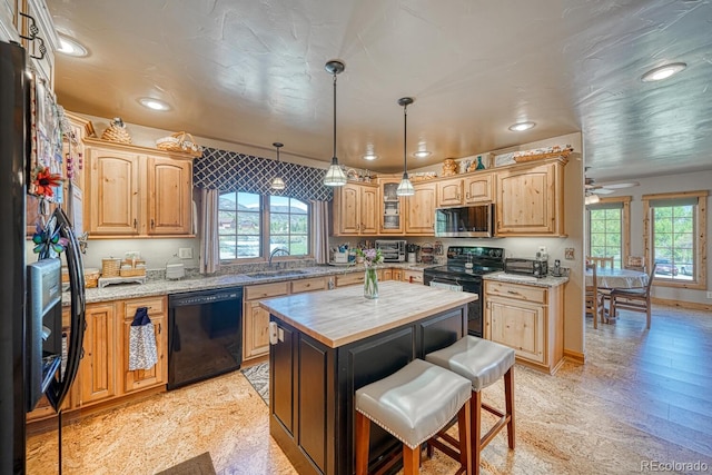 8126 Buck Run, Salida, CO 81201 - kitchen featuring black appliances, butcher block countertops, a center island, a breakfast bar area, and a sink