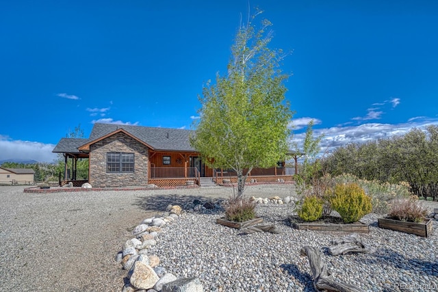 8126 Buck Run, Salida, CO 81201 - view of front of home with a porch, stone siding, and roof with shingles