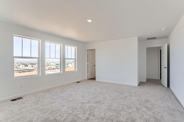 3909 N Shawnee St, Aurora, CO 80019 - unfurnished room with baseboards, visible vents, and light carpet