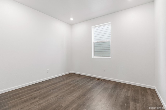 unfurnished room featuring dark wood-type flooring