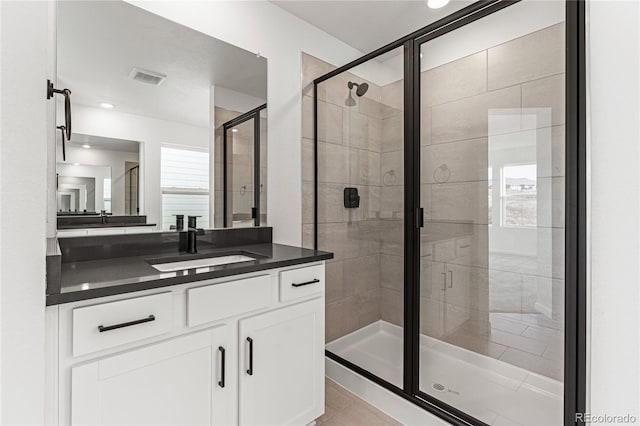 bathroom with vanity, tile patterned floors, and walk in shower