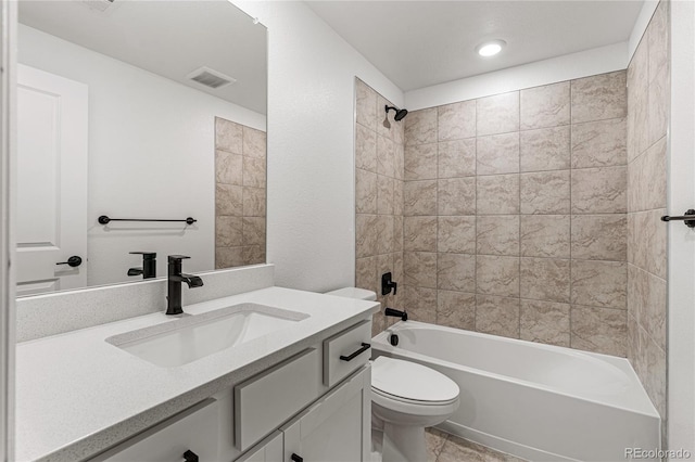 full bathroom featuring vanity, tiled shower / bath combo, and toilet