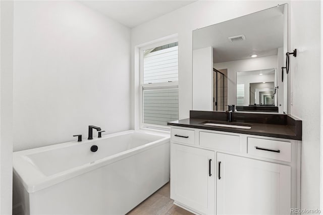 9359 Russell Cir, Arvada, CO 80007 - bathroom with a soaking tub, vanity, a stall shower, and tile patterned flooring