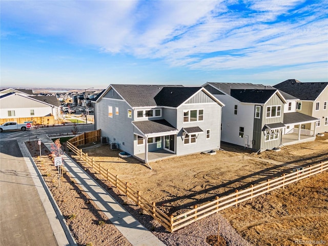 9359 Russell Cir, Arvada, CO 80007 - view of front of home with a residential view, board and batten siding, a fenced backyard, and a patio area