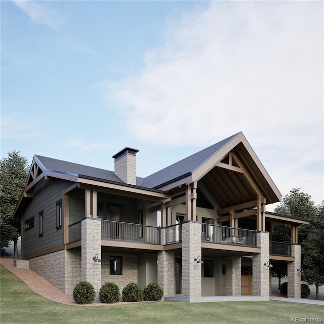 rear view of house featuring a balcony and a yard