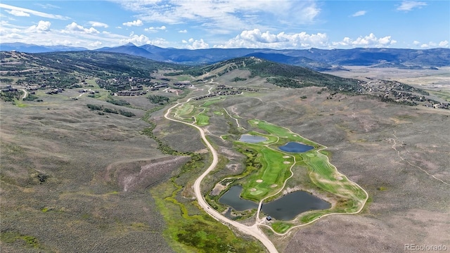 aerial view featuring a water and mountain view