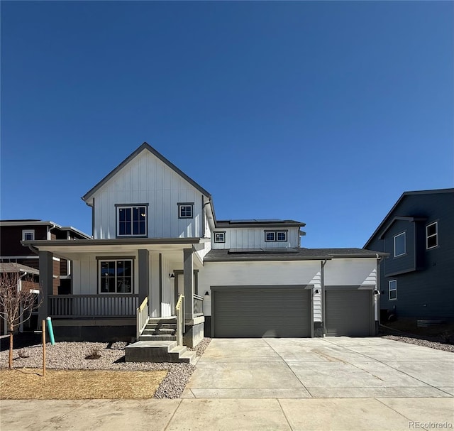 modern farmhouse style home featuring a garage, a porch, concrete driveway, and board and batten siding