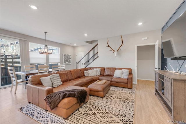 living room featuring an inviting chandelier and light wood-type flooring