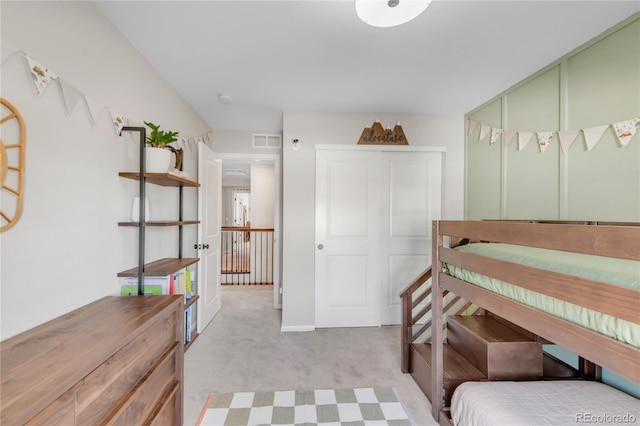 bedroom featuring light carpet