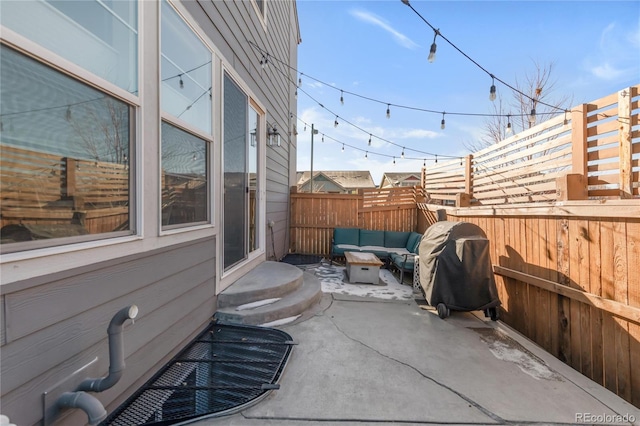 view of patio with area for grilling and an outdoor living space