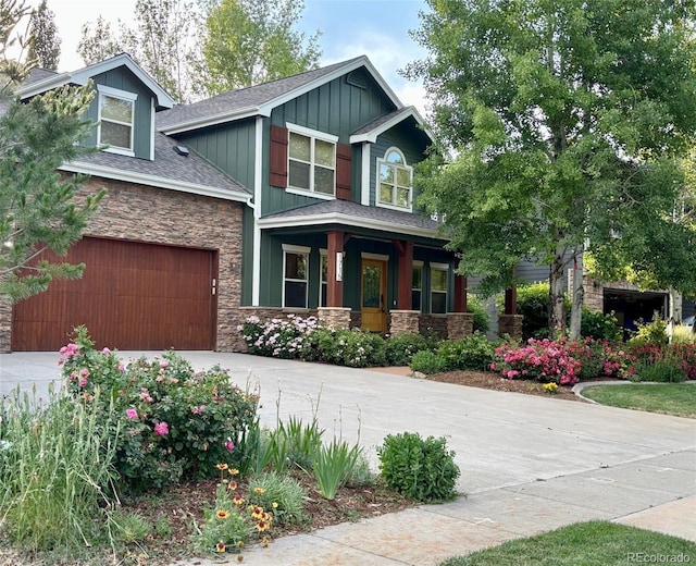 1715 Wales Dr, Berthoud, CO 80513 - craftsman house with stone siding, covered porch, driveway, and a shingled roof