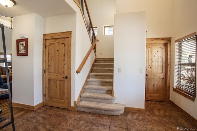 1715 Wales Dr, Berthoud, CO 80513 - stairs with baseboards and a towering ceiling