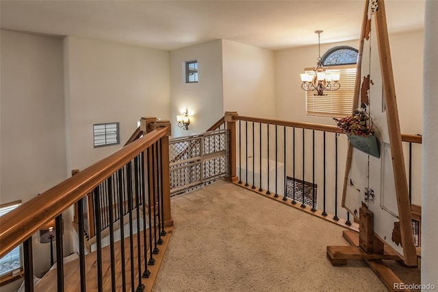 1715 Wales Dr, Berthoud, CO 80513 - hall featuring an upstairs landing, a chandelier, and carpet flooring