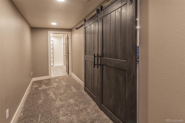 1715 Wales Dr, Berthoud, CO 80513 - hall featuring a barn door, carpet floors, and a textured wall