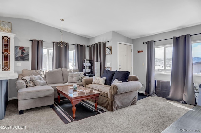living area with an inviting chandelier and lofted ceiling