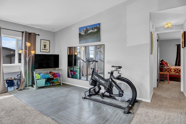 workout area with visible vents, baseboards, and carpet