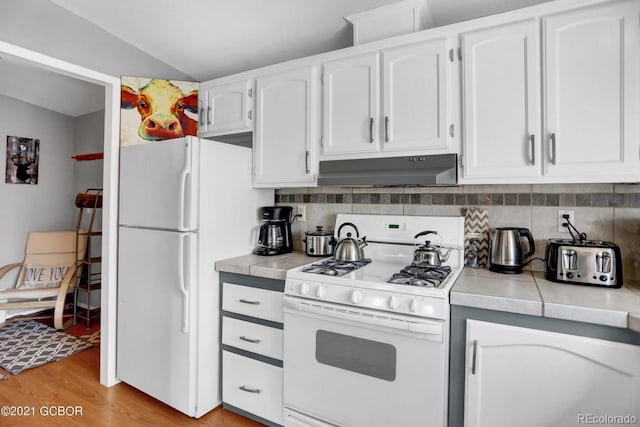 kitchen featuring decorative backsplash, white appliances, white cabinets, and under cabinet range hood