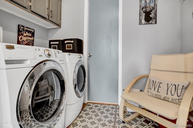 clothes washing area with cabinet space and washer and clothes dryer