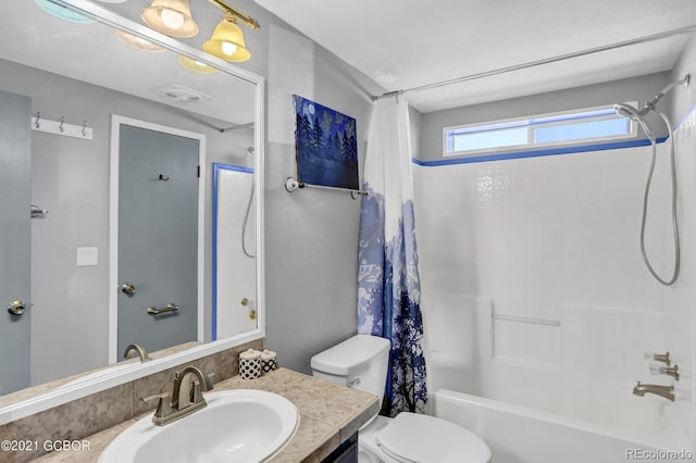 bathroom with vanity, shower / tub combo, and toilet