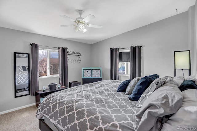 bedroom featuring baseboards, lofted ceiling, carpet, and a ceiling fan