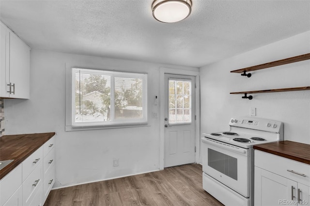 kitchen with butcher block counters, white cabinetry, a textured ceiling, white range with electric cooktop, and light hardwood / wood-style flooring