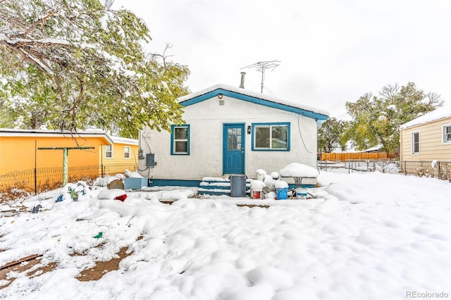 view of snow covered rear of property