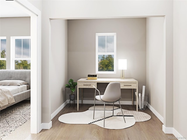 office space with baseboards and wood finished floors