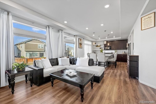 10909 Memphis Ct, Commerce City, CO 80022 - living area featuring wood finished floors, recessed lighting, and baseboards
