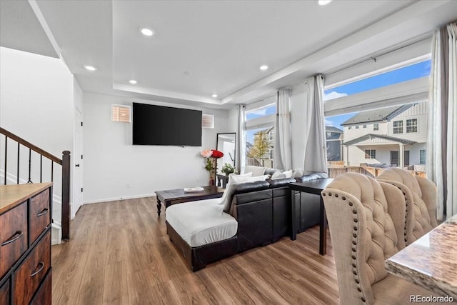 10909 Memphis Ct, Commerce City, CO 80022 - living room with wood finished floors, recessed lighting, stairway, a tray ceiling, and baseboards