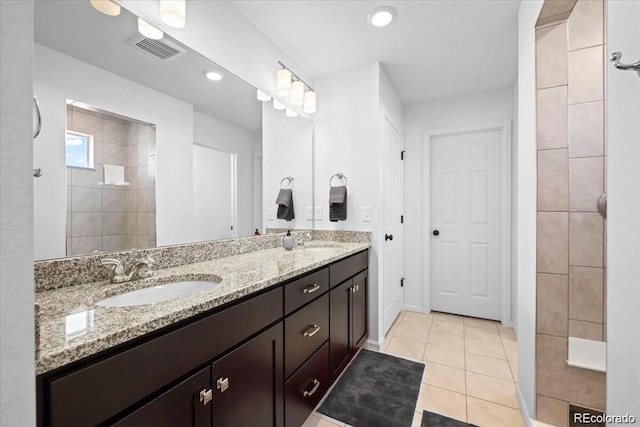 10909 Memphis Ct, Commerce City, CO 80022 - full bathroom featuring double vanity, walk in shower, tile patterned floors, and recessed lighting