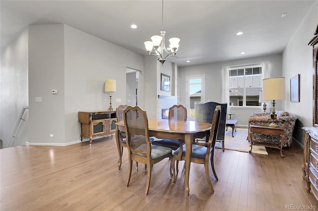 dining room featuring light hardwood / wood-style floors and a notable chandelier