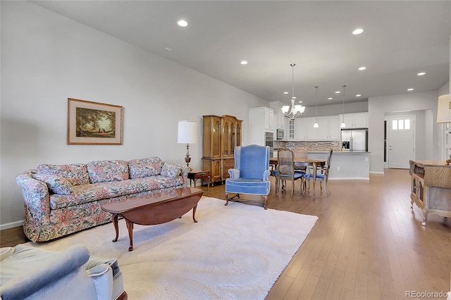 living room featuring an inviting chandelier and light hardwood / wood-style floors