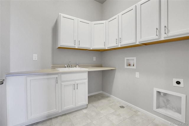 washroom with hookup for an electric dryer, sink, washer hookup, cabinets, and light tile patterned floors