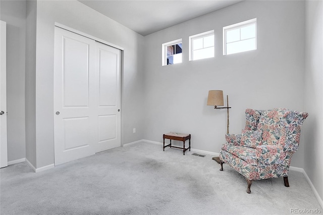 living area featuring light colored carpet