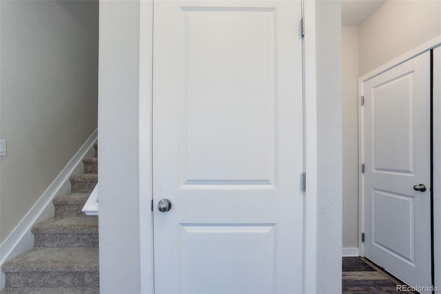 stairs featuring baseboards and wood finished floors