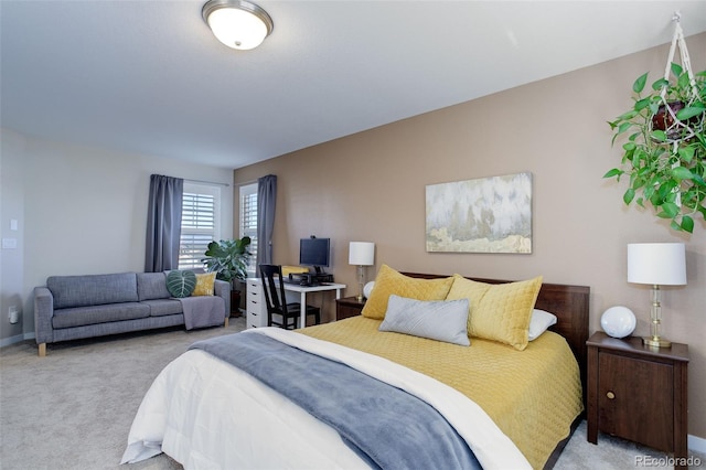 carpeted bedroom featuring baseboards