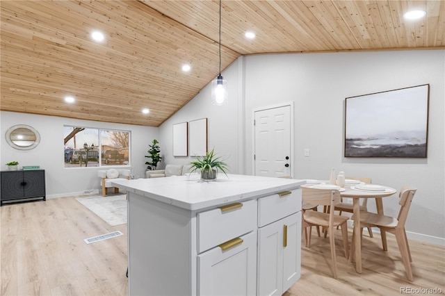 kitchen with white cabinets, light hardwood / wood-style floors, decorative light fixtures, a kitchen island, and wood ceiling