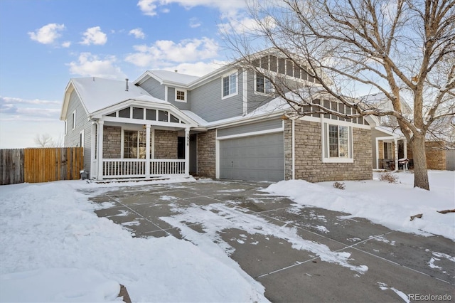 view of front property featuring a porch and a garage