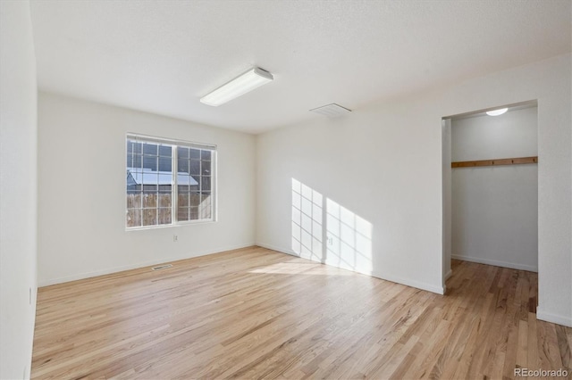 unfurnished room with light wood-type flooring