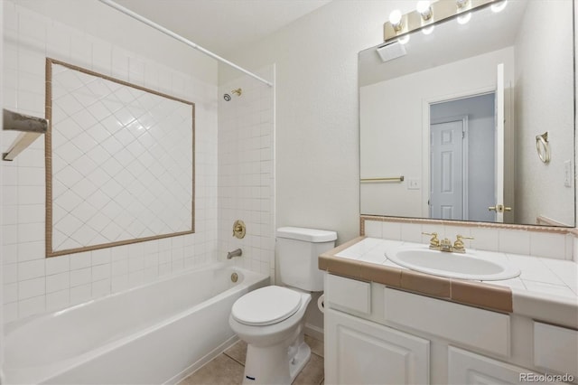 full bathroom featuring tiled shower / bath, vanity, toilet, and tile patterned floors