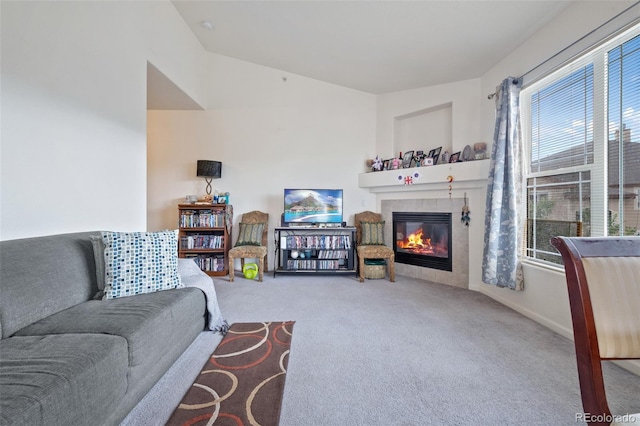 living room featuring a fireplace, lofted ceiling, and carpet