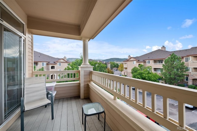 balcony featuring a residential view and a mountain view