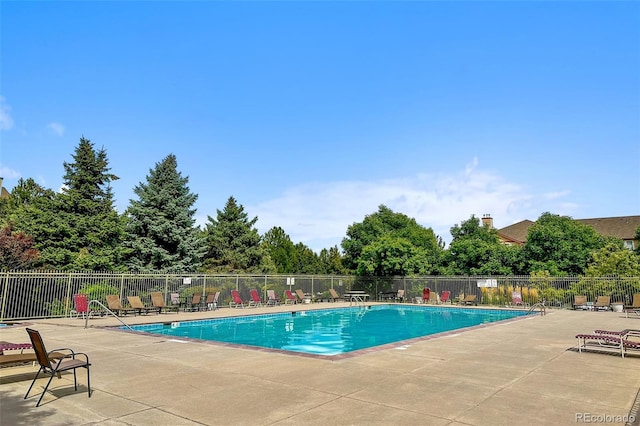 community pool featuring a patio and fence