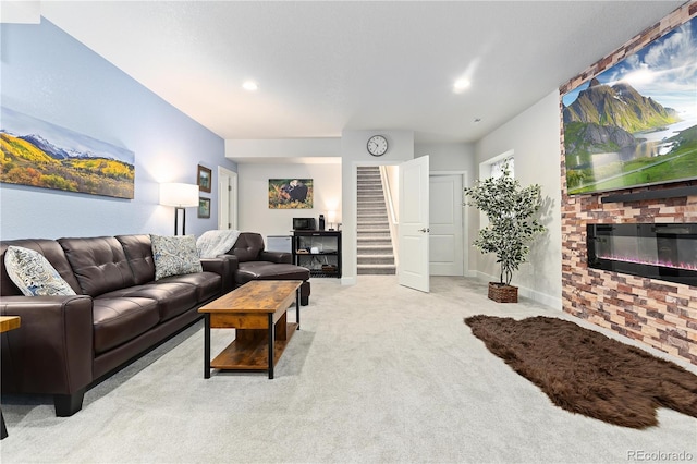 living room with a brick fireplace and light carpet