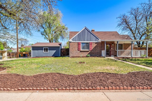 7275 E 8th Ave, Denver, CO 80220 - view of front of property featuring brick siding, a chimney, covered porch, and an outdoor structure
