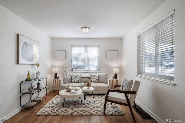 7275 E 8th Ave, Denver, CO 80220 - living area with plenty of natural light, wood finished floors, and baseboards